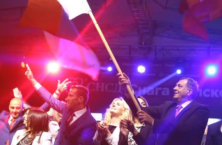 Milorad Dodik (R), President of Republika Srpska, celebrates the results of a referendum over a disputed national holiday during an election rally in Pale, Bosnia and Herzegovina, September 25, 2016. REUTERS/Dado Ruvic