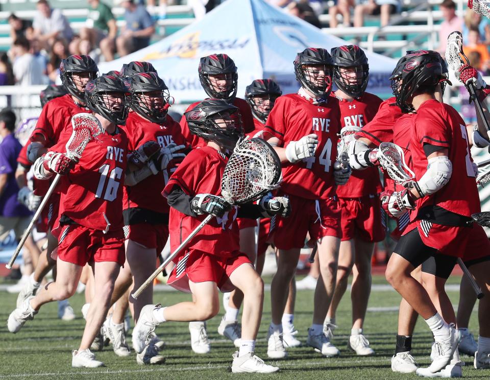 Rye players celebrate their 11-7 victory over John Jay (CR) in the Section 1 Class C championship at Yorktown High School May 29, 2024.