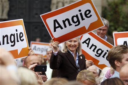 Supporters of the Christian Democratic Union (CDU) hold placards with the nickname of German Chancellor and CDU head Angela Merkel during the party's election campaign event in Osnabrueck September 13, 2013. REUTERS/Ina Fassbender