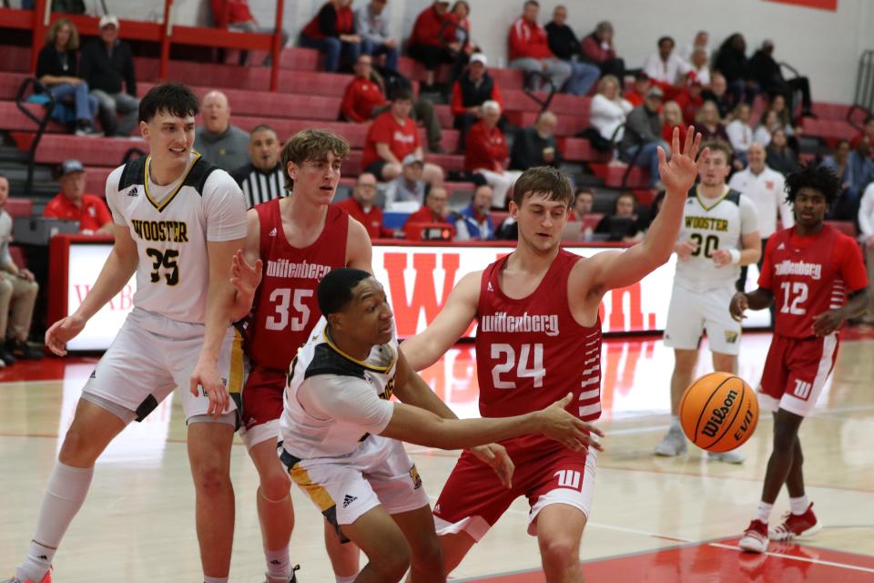 Jamir Billings passes off for one of his six assists in The College of Wooster's NCAC Tournament semifinal win over Wittenberg.