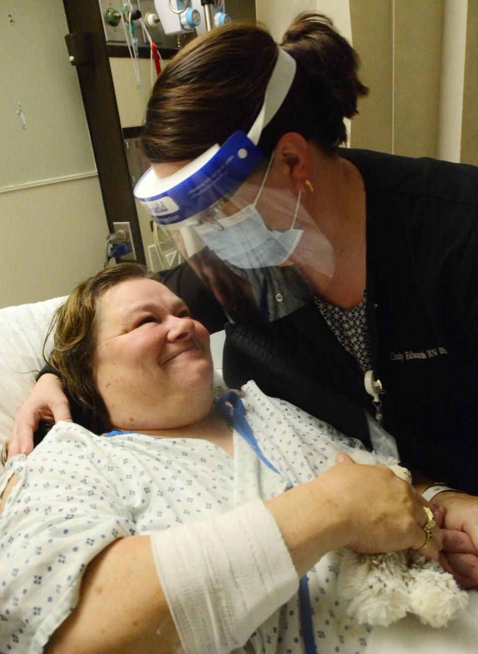 Sandra Swenor of Springfield, Massachusetts, smiles at William W. Backus nurse Cindy Edwards at the Norwich hospital Oct. 27 after Edwards saved her life during a seizure as she waited in line for a recent Blake Shelton concert at the Mohegan Sun Casino.