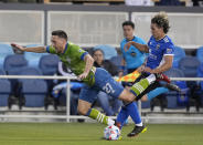 Seattle Sounders defender Shane O'Neill (27) is pushed from behind by San Jose Earthquakes forward Cade Cowell during the first half of an MLS soccer match Wednesday, May 12, 2021, in San Jose, Calif. (AP Photo/Tony Avelar)