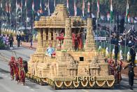 Performers dance next to a float representing Gujarat on Rajpath during the Republic Day parade in New Delhi on January 26, 2021. (Photo by Jewel SAMAD / AFP) (Photo by JEWEL SAMAD/AFP via Getty Images)