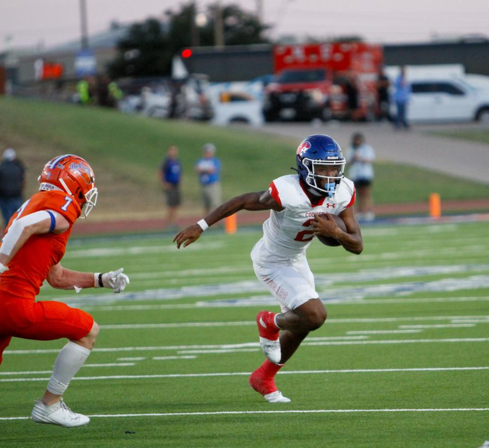 Abilene Cooper running back Daniel Bray (2) runs away from the San Angelo Central defense and toward the end zone Sept. 8 at San Angelo Stadium.