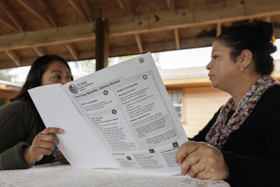 Children's Defense Fund program director Graciela Camarena assists Lucia Salazar with filling out Medicaid and SNAP application forms for her family in Pharr, Texas, Monday, Nov. 13, 2023. As the state reviews Texans' eligibility, some 1 million people have already lost Medicaid and organizations like the one Graciela works for assist people in applying again. (AP Photo/Michael Gonzalez)