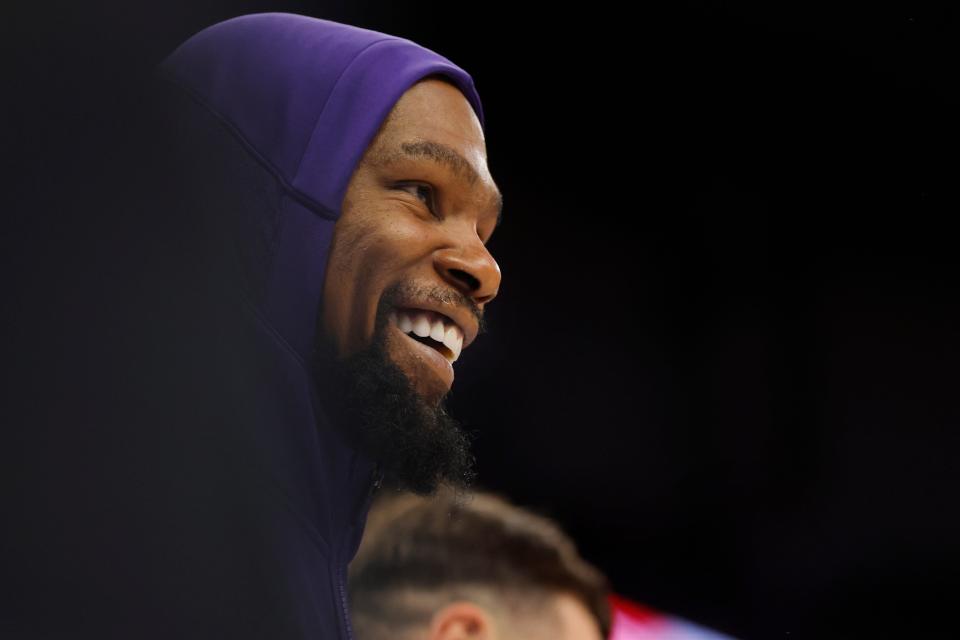 Phoenix Suns forward Kevin Durant (35) smiles from the bench as his teammates defeat the Minnesota Timberwolves late in the fourth quarter at Target Center in Minneapolis on April 14, 2024.