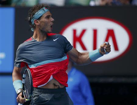 Rafael Nadal of Spain celebrates winning the second set of his men's singles match against Kei Nishikori of Japan at the Australian Open 2014 tennis tournament in Melbourne January 20, 2014. REUTERS/Petar Kujundzic