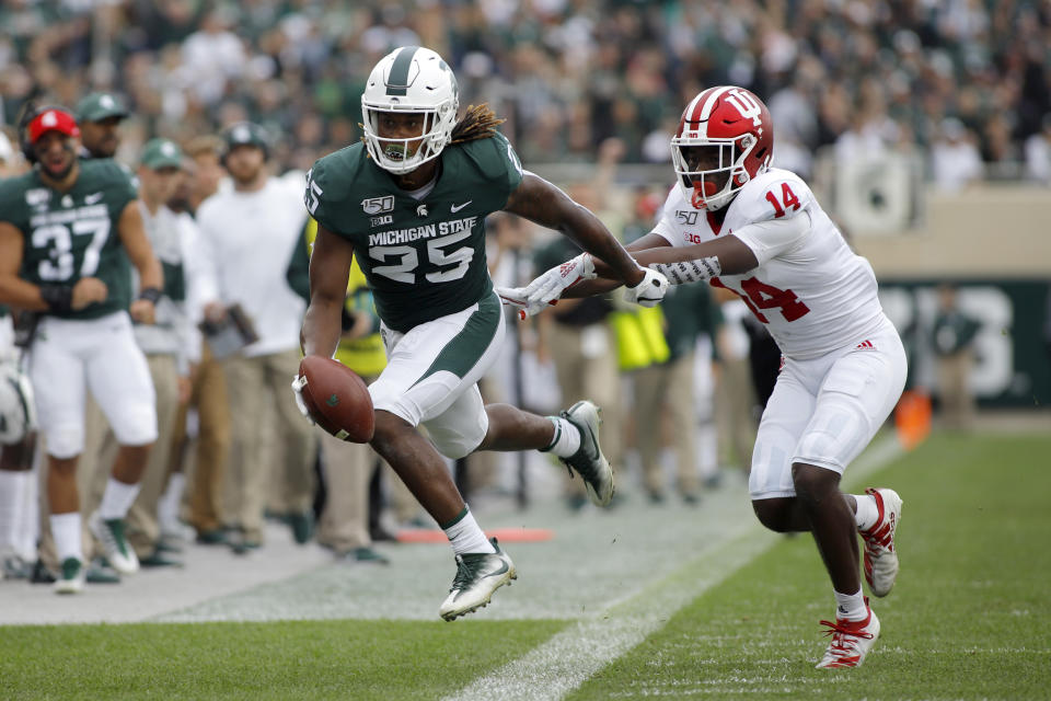 Michigan State receiver Darrell Stewart, left, is pushed out of bounds by Indiana's Andre Brown (14) after a pass reception during the first quarter of an NCAA college football game, Saturday, Sept. 28, 2019, in East Lansing, Mich. (AP Photo/Al Goldis)