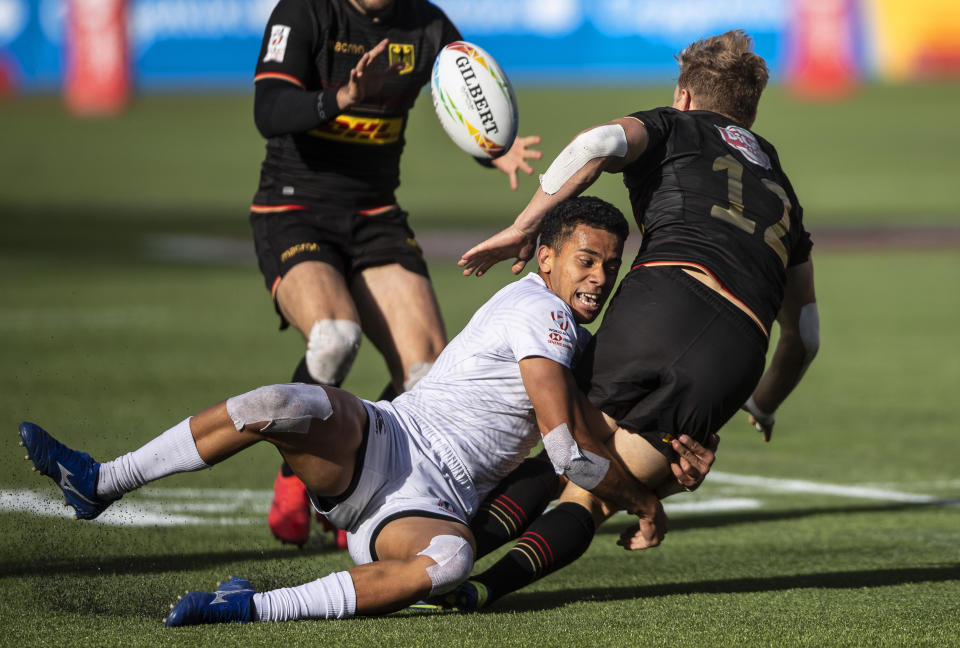 Jack Wendling, front left, of the United States, tackles Germany's Tim Lichtenberg, right, during an HSBC Canada Sevens fifth-place playoff rugby match in Edmonton, Alberta, Sunday, Sept. 26, 2021. (Jason Franson/The Canadian Press via AP)