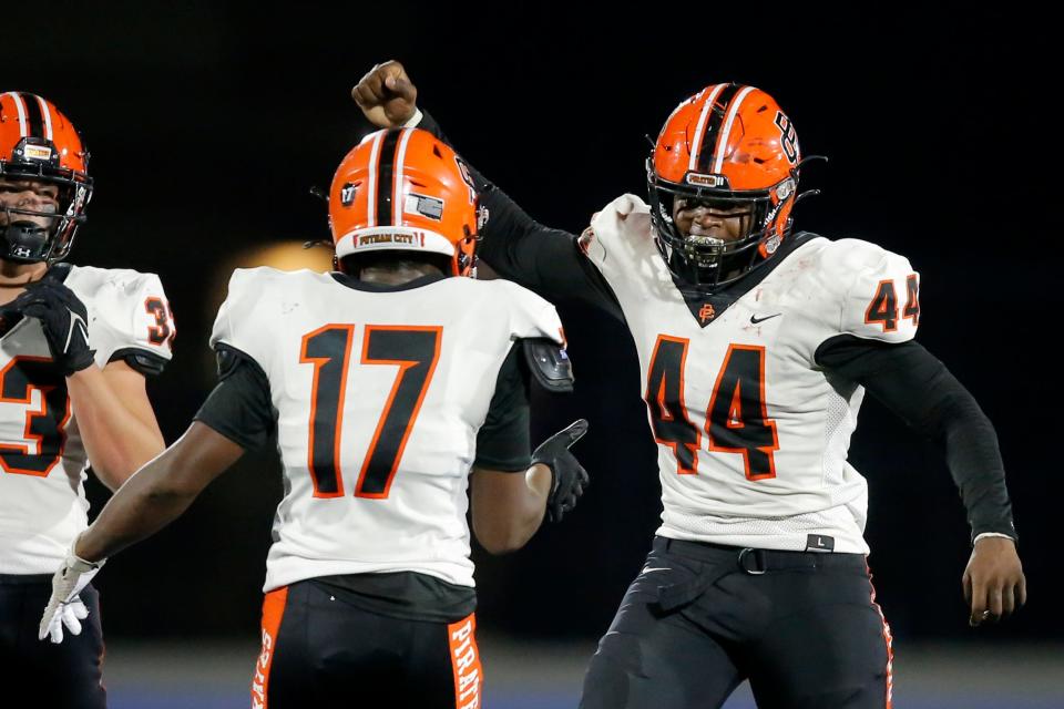 Putnam City's Taje McCoy, right, celebrates after a sack  during a high school football game between the Deer Creek Antlers and the Putnam City Pirates at Deer Creek, Friday, Sept. 30, 2022. 