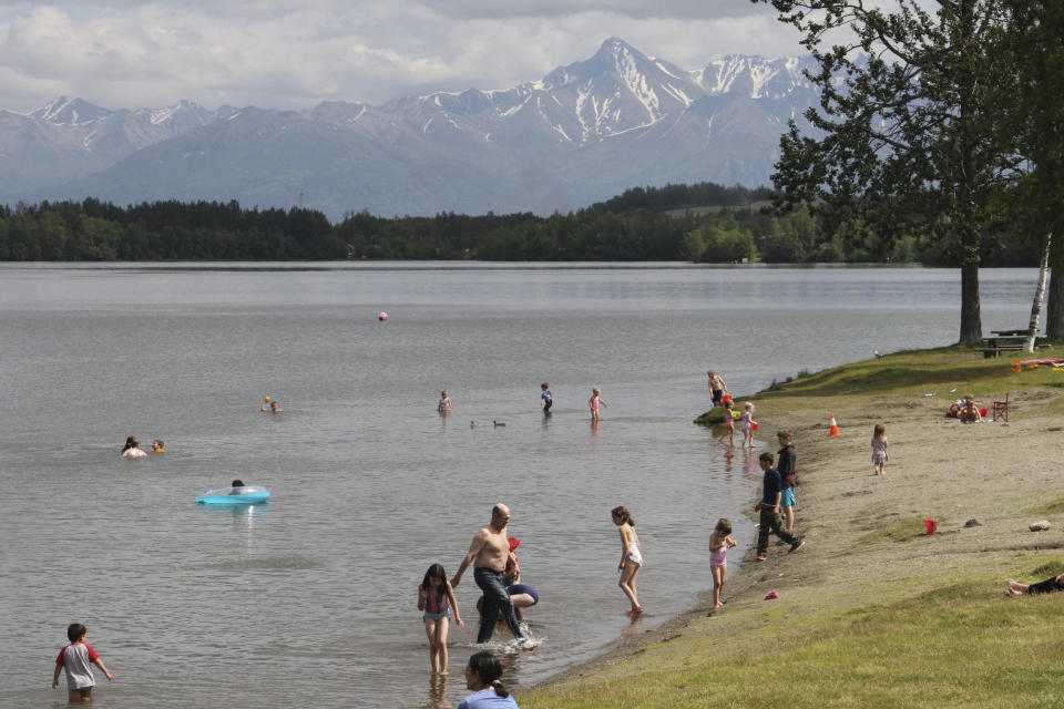This June 14, 2019, photo shows people cooling off in Wasilla Lake in Wasilla, Alaska. Alaska Gov. Mike Dunleavy has called lawmakers into special session in Wasilla beginning July 8, but some lawmakers have expressed concerns over security and logistics with the location more than 500 miles from the state capital of Juneau, Alaska. (AP Photo/Mark Thiessen)