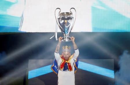 Football Soccer- UEFA Champions League Final - Real Madrid team celebrates at their stadium after winning title- Santiago Bernabeu Stadium, Madrid, Spain - 4/6/17 Real Madrid's Sergio Ramos holds up the Champions League trophy during a victory ceremony. REUTERS/Susana Vera