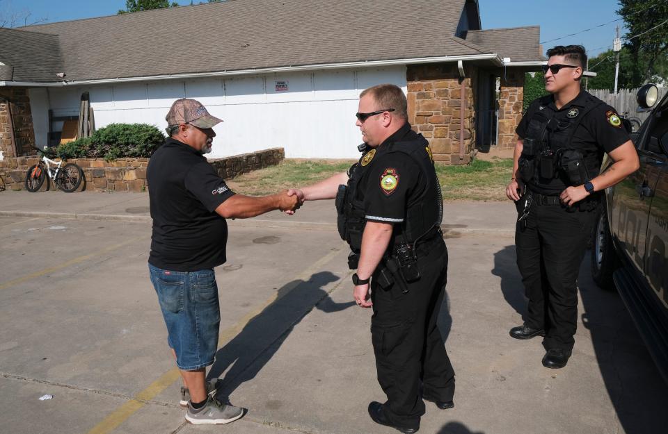A man thanks Muscogee Nation Lighthorse Police Officer Kyle Johnson. Johnson and Officer Daryl Wilson had stopped at the building in Tulsa because Johnson wanted to check on the welfare of a woman who often sleeps nearby.