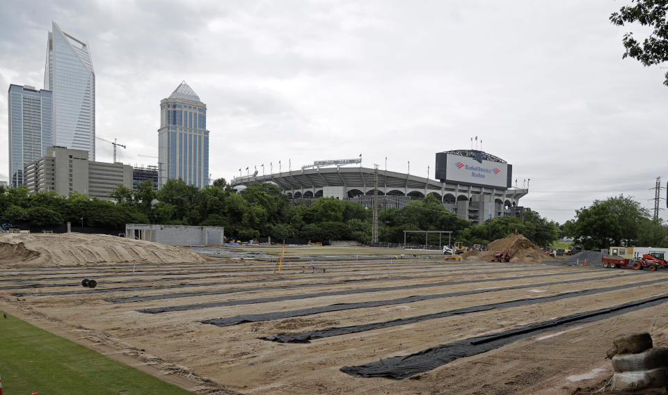 Work continues on a domed practice field for the Carolina Panthers in the shadow of Bank of America stadium during the NFL football team's rookie camp Charlotte, N.C., Saturday, May 11, 2019. (AP Photo/Chuck Burton)
