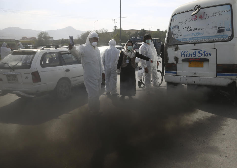 In this Wednesday, Oct. 16, 2019. photo, smoke comes out from silencer of an old mini-bus in Kabul, Afghanistan. Authorities are trying to tackle pollution in the country’s capital, which may be even deadlier than 18-year-old war. Most days a layer of smog covers Kabul, and it gets worse in the winter, when people burn coal, garbage, plastic and rubber to heat their homes. (AP Photo/Rahmat Gul)