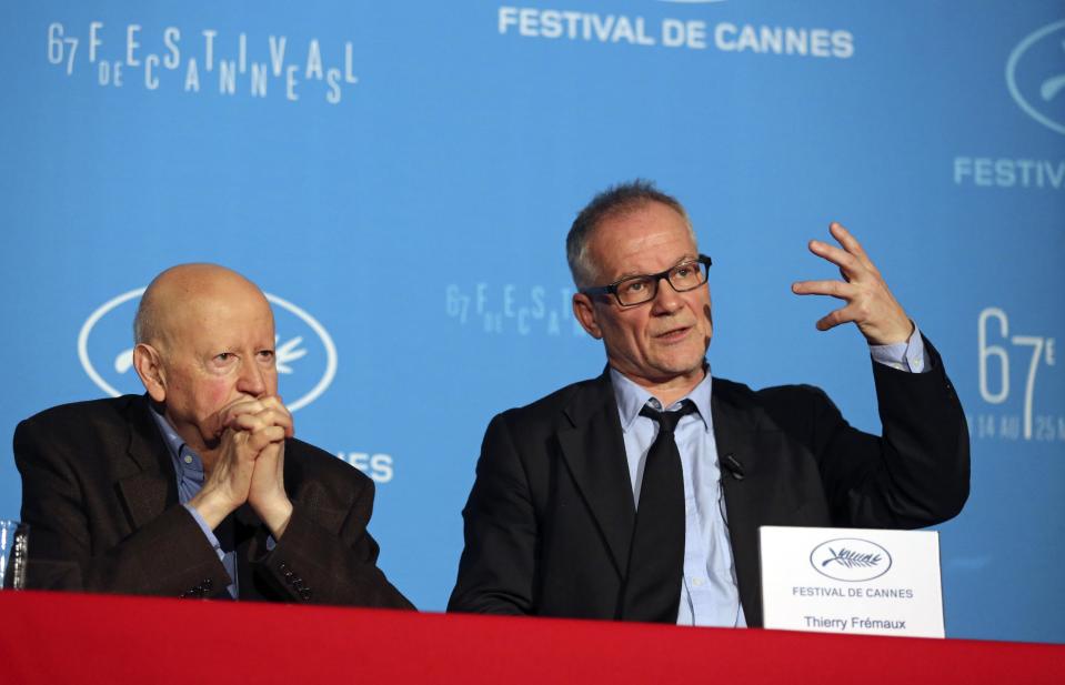 Cannes Film Festival general delegate Thierry Fremaux, right, addresses reporters, as Festival President Gilles Jacob, left, looks on, during a press conference to announce this years line up in Paris, Thursday April 17, 204. A Tommy Lee Jones western and a David Cronenberg exposé on Hollywood are among the 18 films vying for the top prize at the Cannes Film Festival. The festival organizers also said Thursday that two women directors and famed New Wave filmmaker Jean-Luc Godard will be in competition at the festival that runs May 14-25. (AP Photo/Remy de la Mauviniere)