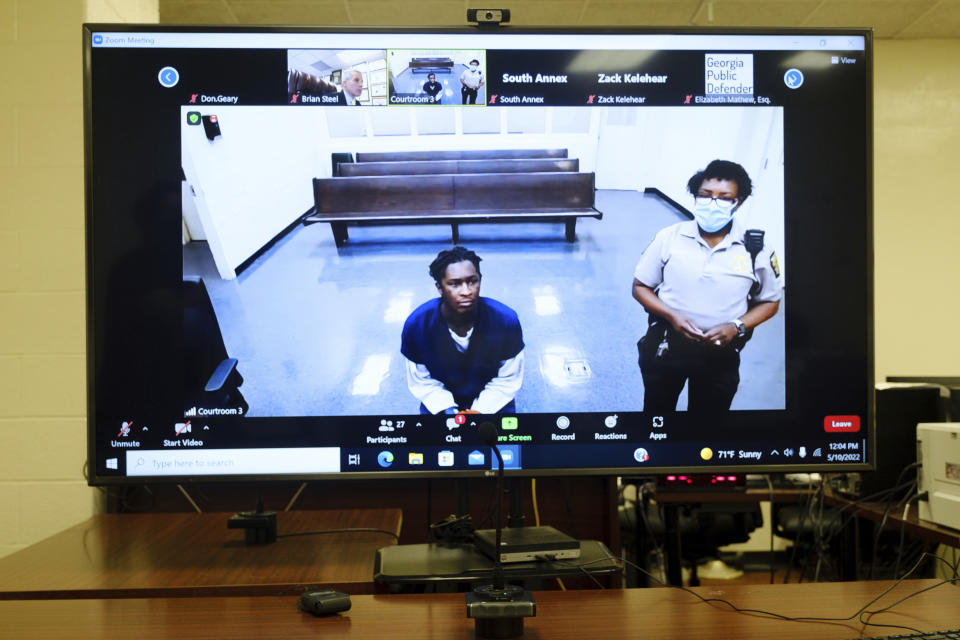 Atlanta rapper Young Thug, whose real name is Jeffery Lamar Williams, is displayed on a monitor as he waits during a virtual appearance before a Fulton County Magistrate judge on Tuesday, May 10, 2022, in Atlanta. The Atlanta rapper accused of co-founding a criminal street gang in Atlanta that prosecutors say committed multiple murders and shootings over roughly a decade. (Arvin Temkar/Atlanta Journal-Constitution via AP)