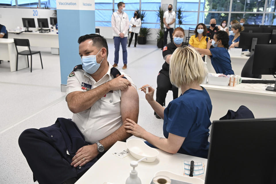 Ben Shepherd from the Rural Fire Service receives a Pfizer vaccine at the newly opened COVID-19 Vaccination Centre in Sydney Monday, May 10, 2021. (Nick Moir/Pool Photo via AP)