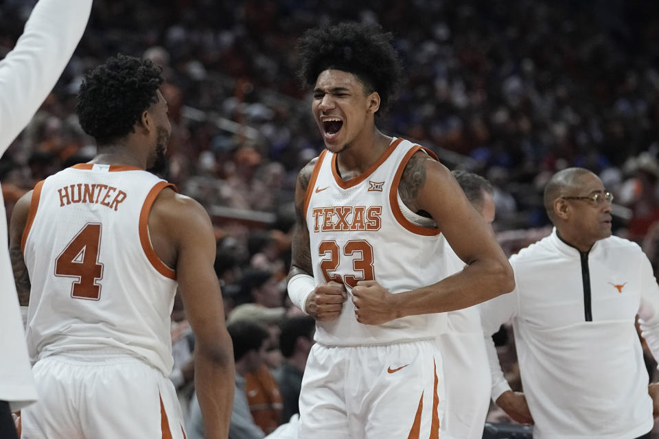 Texas forward Dillon Mitchell (23) and guard Tyrese Hunter (4) celebrate a score against Kansas during the second half of an NCAA college basketball game in Austin, Texas, Saturday, March 4, 2023. (AP Photo/Eric Gay)