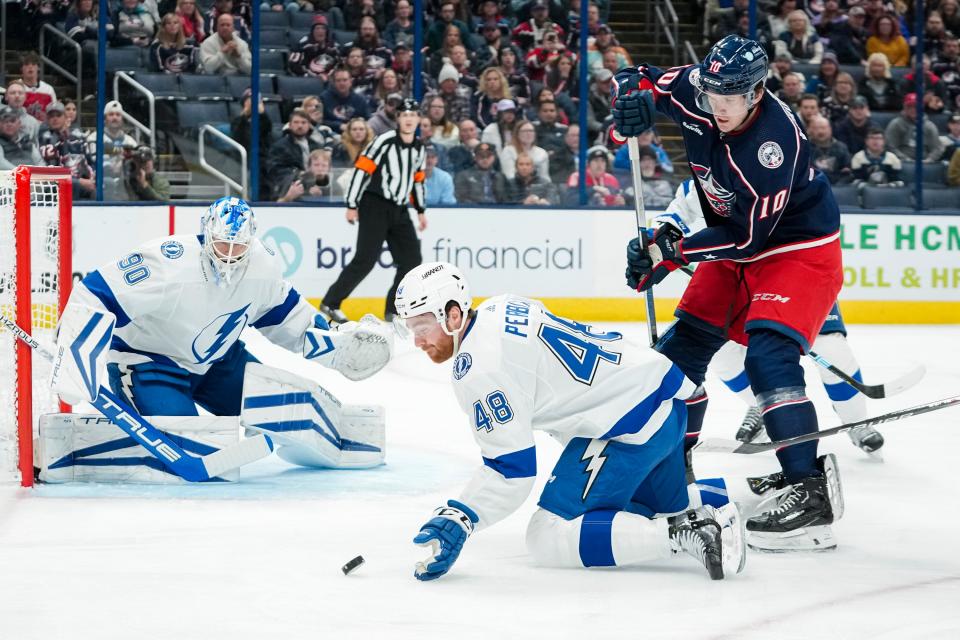 Nov 1, 2023; Columbus, Ohio, USA; Tampa Bay Lightning defenseman Nick Perbix (48) bats the puck away from Columbus Blue Jackets left wing Dmitri Voronkov (10) during the first period of the NHL hockey game at Nationwide Arena.