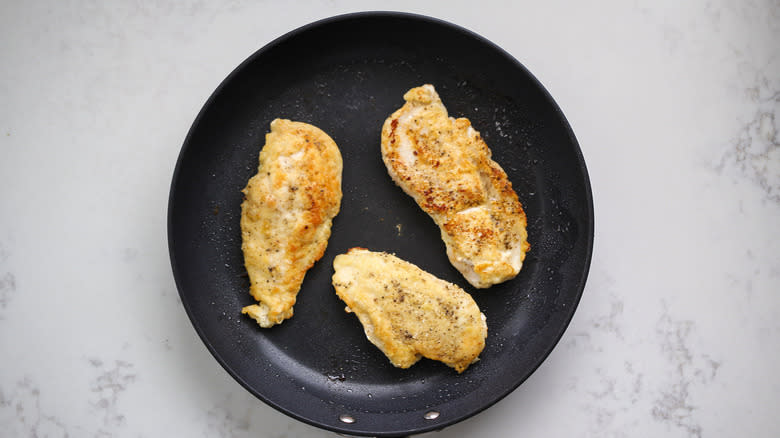 chicken in black frying pan