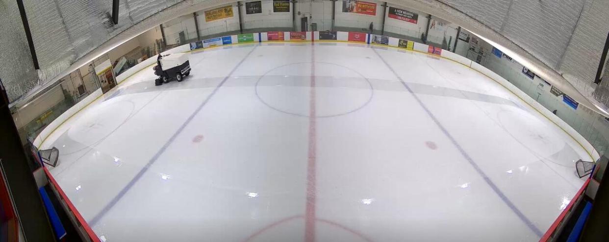 A zamboni crosses across Harold Latrace Arena in Saskatoon, filmed by a camera along the wall and streamed to LiveBarn, a subscription website that allows users to watch local ice sports live and on demand. (Dayne Patterson/LiveBarn - image credit)