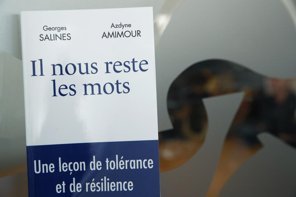 The book written by George Salines, whose daughter died in the Bataclan concert hall during the Nov. 13, 2015, attacks in Paris, with Azdyne Amimour, whose son was among the gunmen that night, is pictured in Paris, Tuesday Jan. 21, 2020. Both men lost children that night. The book, "We Still Have Words" is written as a dialogue between the two, to teach tolerance and resilience at a time when they say both seem in short supply. (AP Photo/Francois Mori)