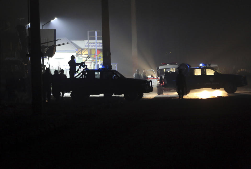 Policemen block the road near the site of a suicide attack in Kabul, Afghanistan, Monday, Jan. 14, 2019. Afghan officials say multiple people were killed when a suicide bomber detonated a vehicle full of explosive in the capital Kabul on Monday. (AP Photo/Massoud Hossaini)