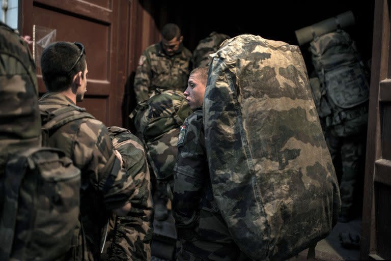 French soldiers load their bags into a container before leaving Afghanistan on Septembre 29, 2012. France has flown its last combat troops out of Afghanistan, two years before allied nations in the 100,000-strong NATO mission led by the United States are due to recall their fighting forces