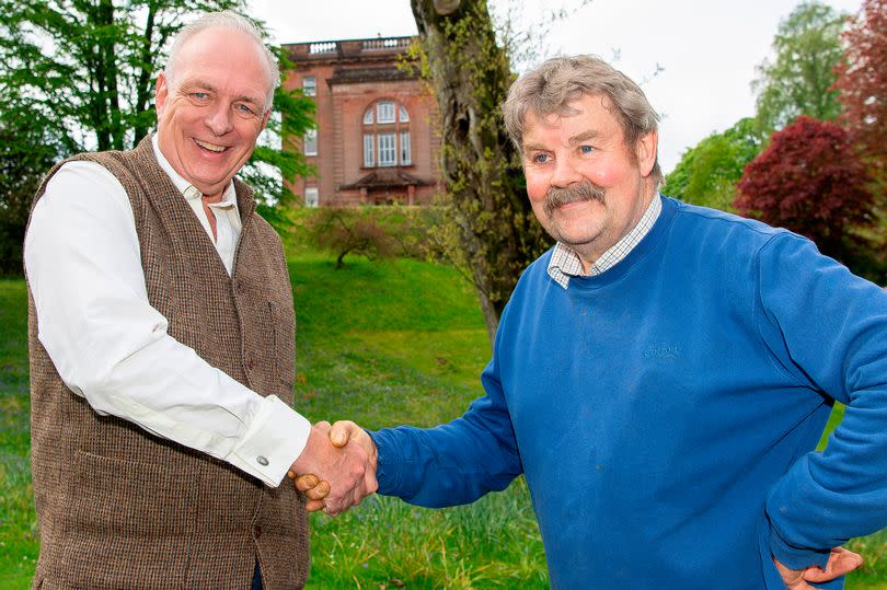 Dalswinton gardener Sandy Hutchinson is congratulated on his retirement by Peter Landale