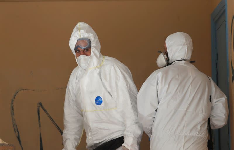 Municipal workers wearing personal protective equipment (PPE) disinfect a school, on the first day of the easing of a nationwide lockdown against the spread of the coronavirus disease (COVID-19), in Athens