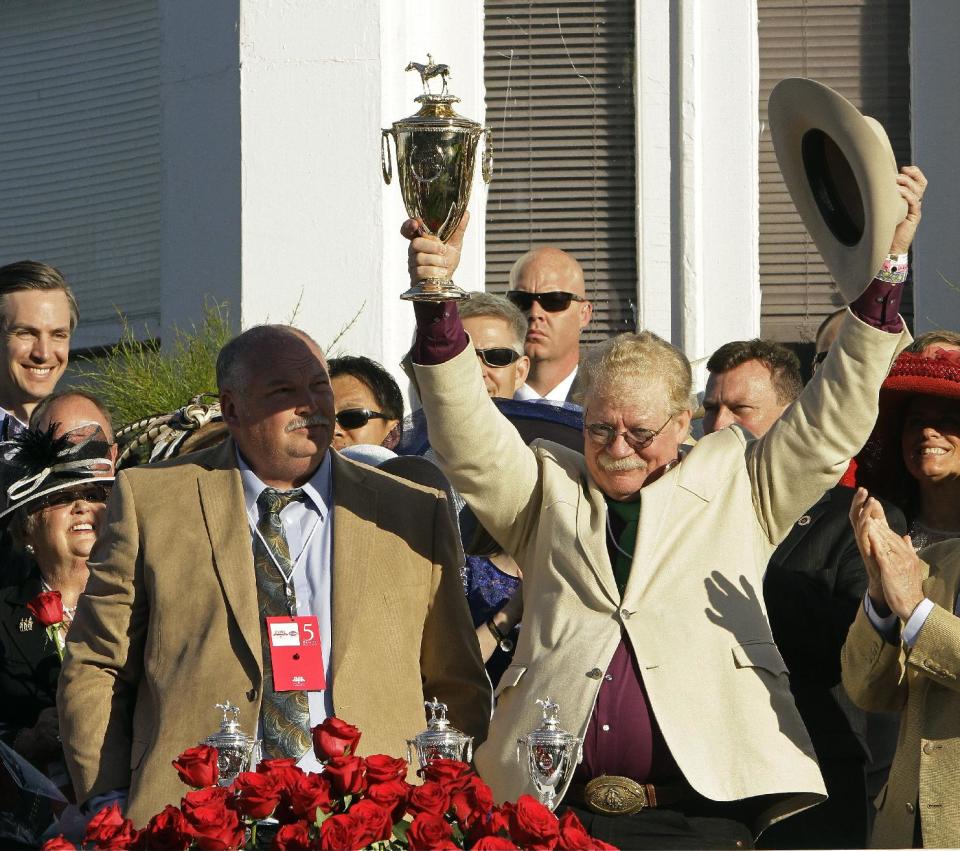 California Chrome owner Steven Coburn, right, and Perry Martin celebrate after Victor Espinoza rode California Chrome to victory in the 140th running of the Kentucky Derby horse race at Churchill Downs Saturday, May 3, 2014, in Louisville, Ky. (AP Photo/Garry Jones)
