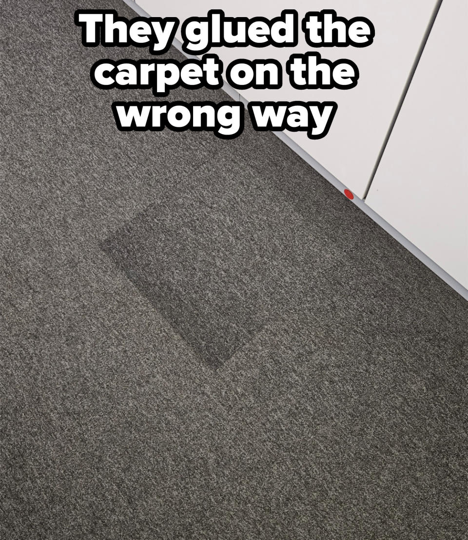 Patch of damp carpet near a white cabinet