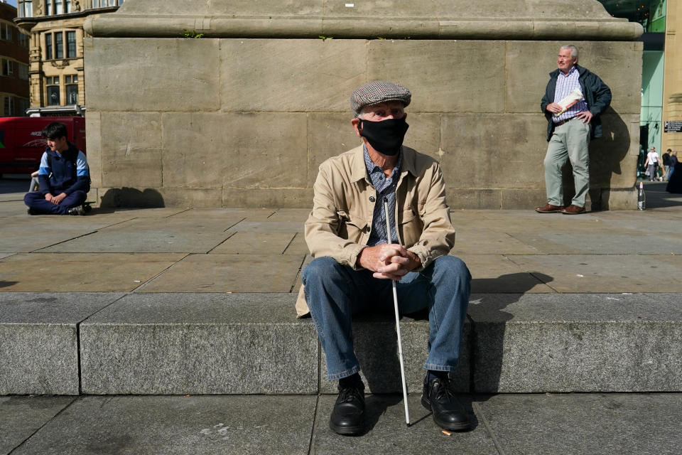 NEWCASTLE UPON TYNE, ENGLAND - SEPTEMBER 17: A man sits at the bottom of Grey's Monument in Newcastle on September 17, 2020 in Newcastle upon Tyne, England. Almost two million people in north-east England will be banned from mixing with other households and pubs will close early as coronavirus cases rise. Health Secretary Matt Hancock announced the temporary restrictions will be in place from midnight due to concerning rates of infection. The measures affect seven council areas, Newcastle, Northumberland, North Tyneside, South Tyneside, Gateshead, County Durham and Sunderland. (Photo by Ian Forsyth/Getty Images)