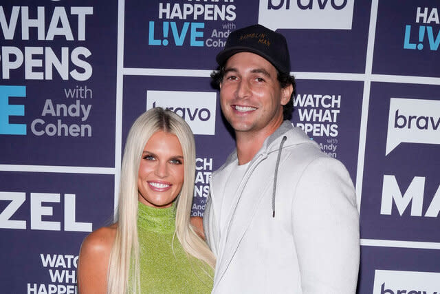 Madison Lecroy and her husband Brett Randle in front of a step and repeat at WWHL.