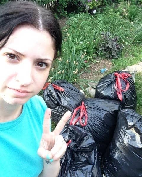 the sister standing outside with trash bags filled