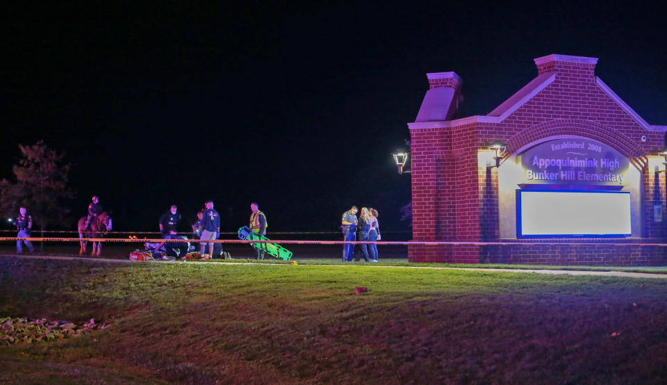 Emergency personnel treat a shooting victim near the entrance to the Appoquinimink High School campus as a football game between Middletown and Appoquinimink High Schools was ending on Sept 23, 2022, in Wilmington, Del. (William Bretzger/ / Delaware News Journal / USA Today Network)