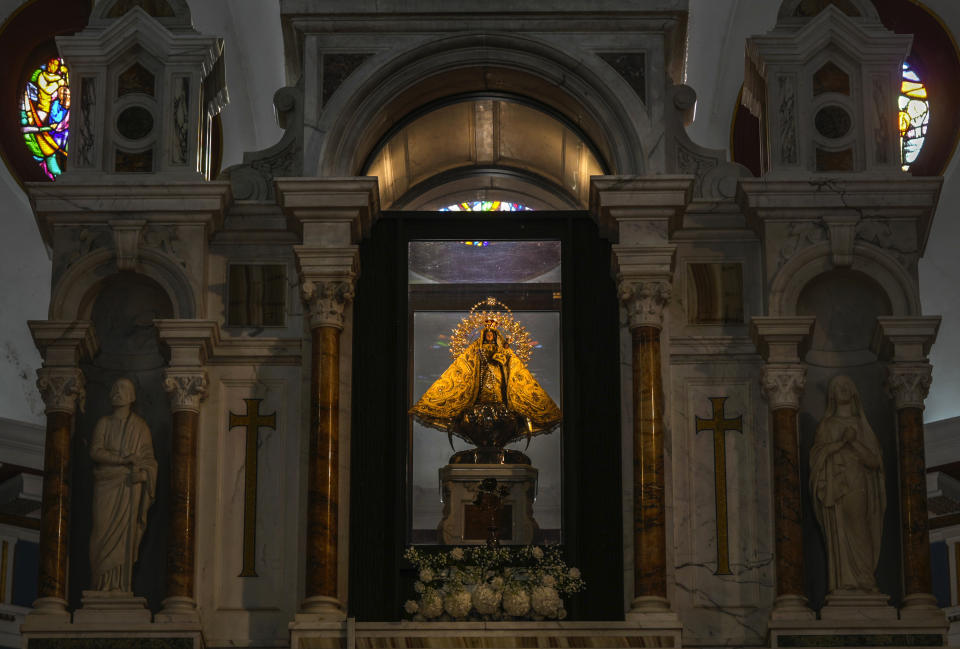 The original statue of the Virgin of Charity of El Cobre stands behind the altar at her shrine in El Cobre, Cuba, Sunday, Feb. 11, 2024. The Vatican-recognized Virgin, venerated by Catholics and followers of Afro-Cuban Santeria traditions, is at the heart of Cuban identity, uniting compatriots from the Communist-run Caribbean island to those who were exiled or emigrated to the U.S. (AP Photo/Ramon Espinosa)