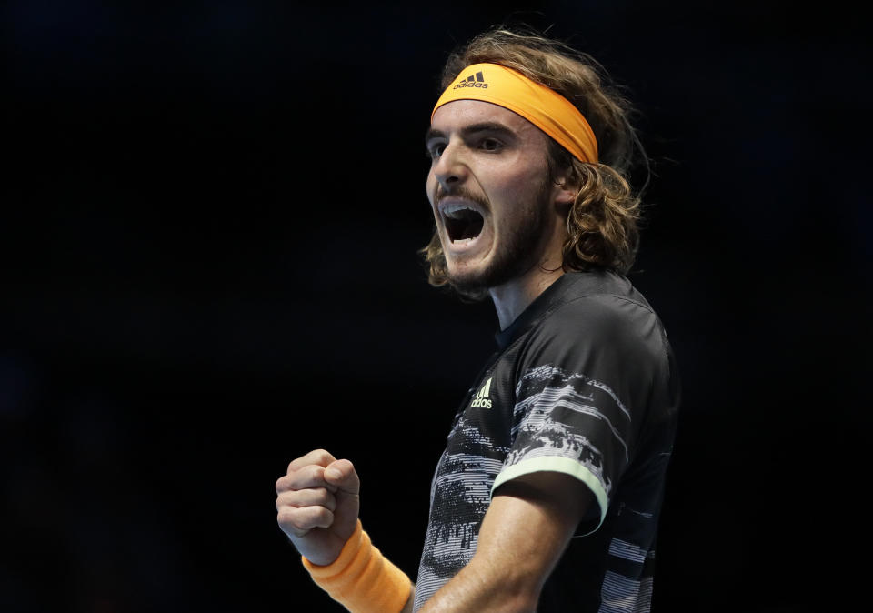 Stefanos Tsitsipas of Greece celebrates winning a point against Roger Federer of Switzerland during their ATP World Tour Finals semifinal tennis match at the O2 Arena in London, Saturday, Nov. 16, 2019. (AP Photo/Kirsty Wigglesworth)