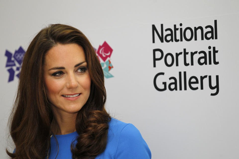 Kate, Duchess of Cambridge reacts as she listens to a speech during her visit to 'Road to 2012 : Aiming High' exhibition at the National Portrait Gallery in London, Thursday, July 19, 2012. The Duchess of Cambridge is the Patron of the National Portrait Gallery. The exhibition showcase commissioned photographs documenting the preparations for London 2012 Olympics. (AP Photo/Sang Tan, Pool)