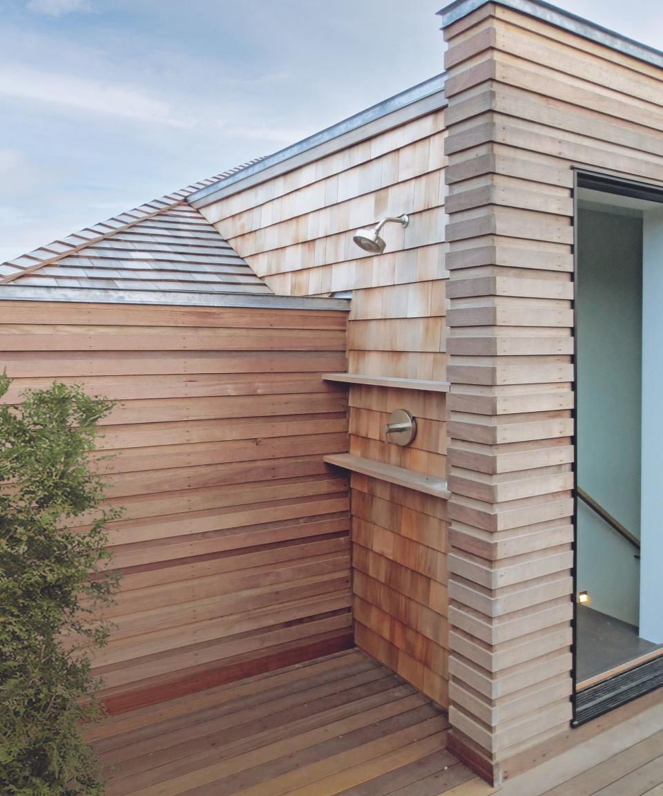 Outdoor bathroom / shower room with wood-clad walls