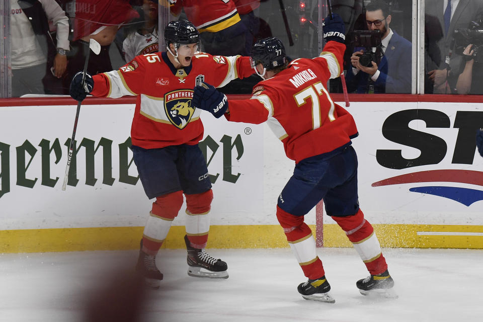 Florida Panthers defenseman Niko Mikkola (77) celebrates after his goal with center Anton Lundell (15) during the second period of Game 2 of the NHL hockey Stanley Cup Finals against the Edmonton Oilers, Monday, June 10, 2024, in Sunrise, Fla. (AP Photo/Michael Laughlin)