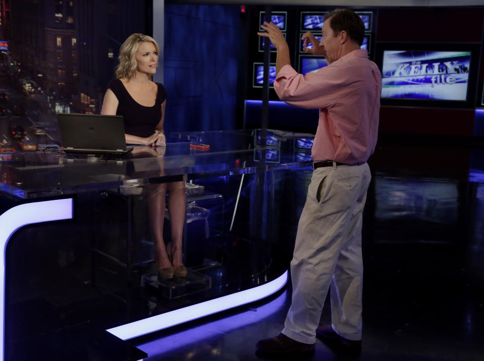 Megyn Kelly, host of Fox News Channel's "The Kelly Files," talks with executive producer Tom Lowell during rehearsals for the debut of her new show, in New York, Friday, Oct. 4, 2013. Her program is the linchpin to the first overhaul of Fox's prime-time lineup since 2002, or about a century in television time. Kelly is keeping Lowell, her executive producer when she had the 1 to 3 p.m. shift, in the same role at night. (AP Photo/Richard Drew)