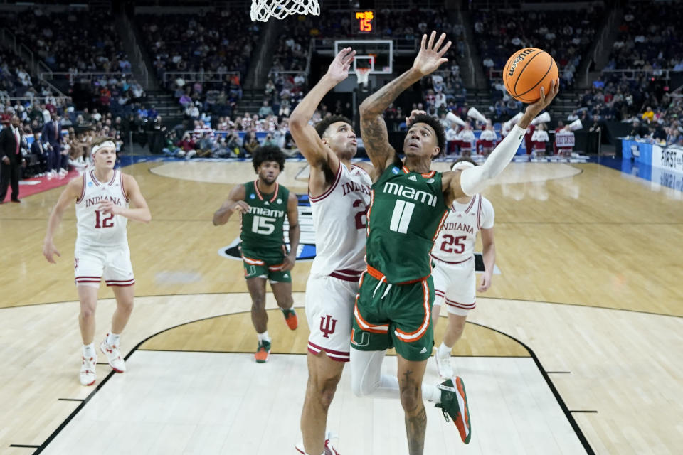 Miami's Jordan Miller (11) shoots against Indiana's Trayce Jackson-Davis, center left, in the second half of a second-round college basketball game in the NCAA Tournament, Sunday, March 19, 2023, in Albany, N.Y. (AP Photo/John Minchillo)