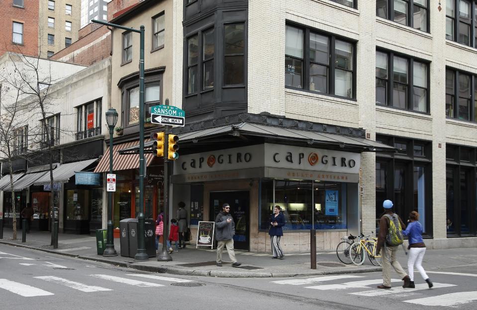 In this Tuesday, April 1, 2014 photo, pedestrians walk along 13th Street near Capogiro gelato in Philadelphia. Tourism officials will tell you the restaurant-rich area in the heart of downtown is called Midtown Village, but that moniker hasn't entirely caught on with locals. Philadelphia food lovers just know 13th Street as a vibrant area chock full of great eateries and wine bars. (AP Photo/Matt Slocum)