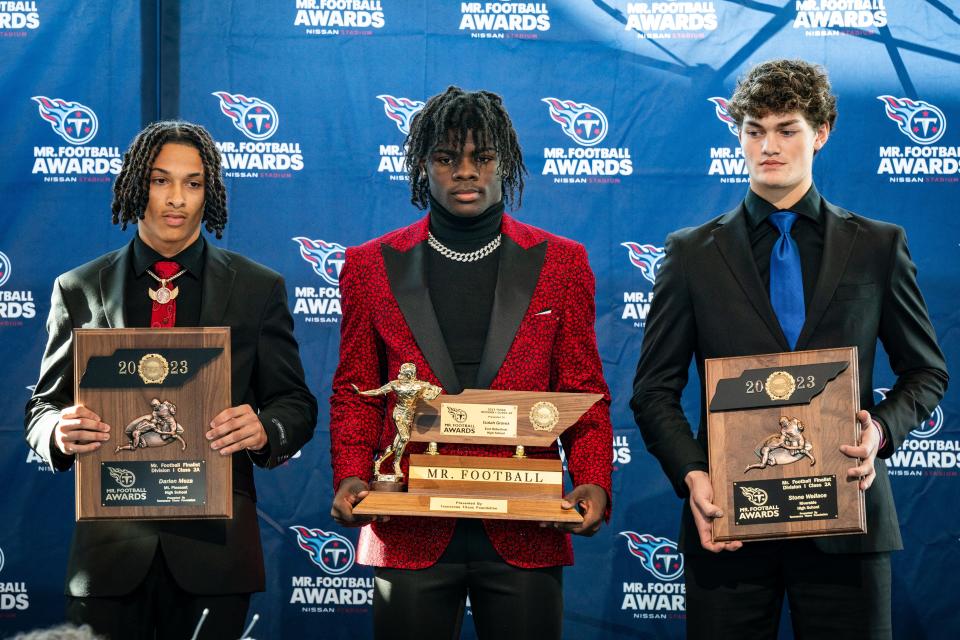 Division 1 Class 2A Mr. Football Award winner Isaiah Groves, center, poses for a photo with finalists Darien Meza, left, and Stone Wallace, right, during the Mr. Football Awards at Nissan Stadium in Nashville, Tenn., Tuesday, Dec. 5, 2023.