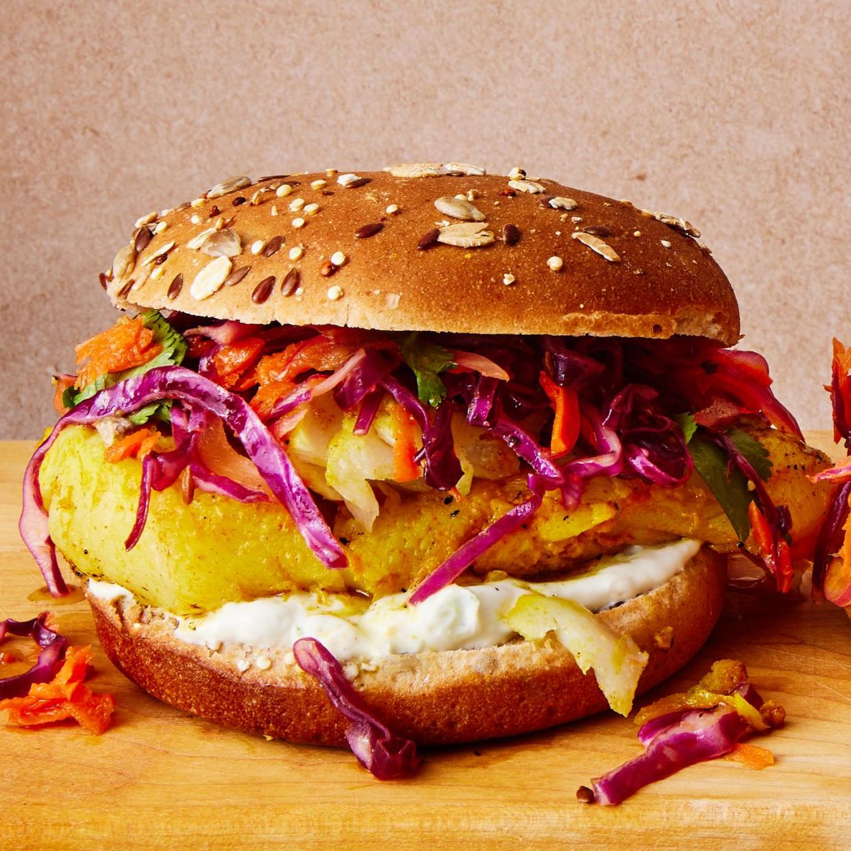 grilled fish sandwich with slaw and tzatziki on a multigrain bun