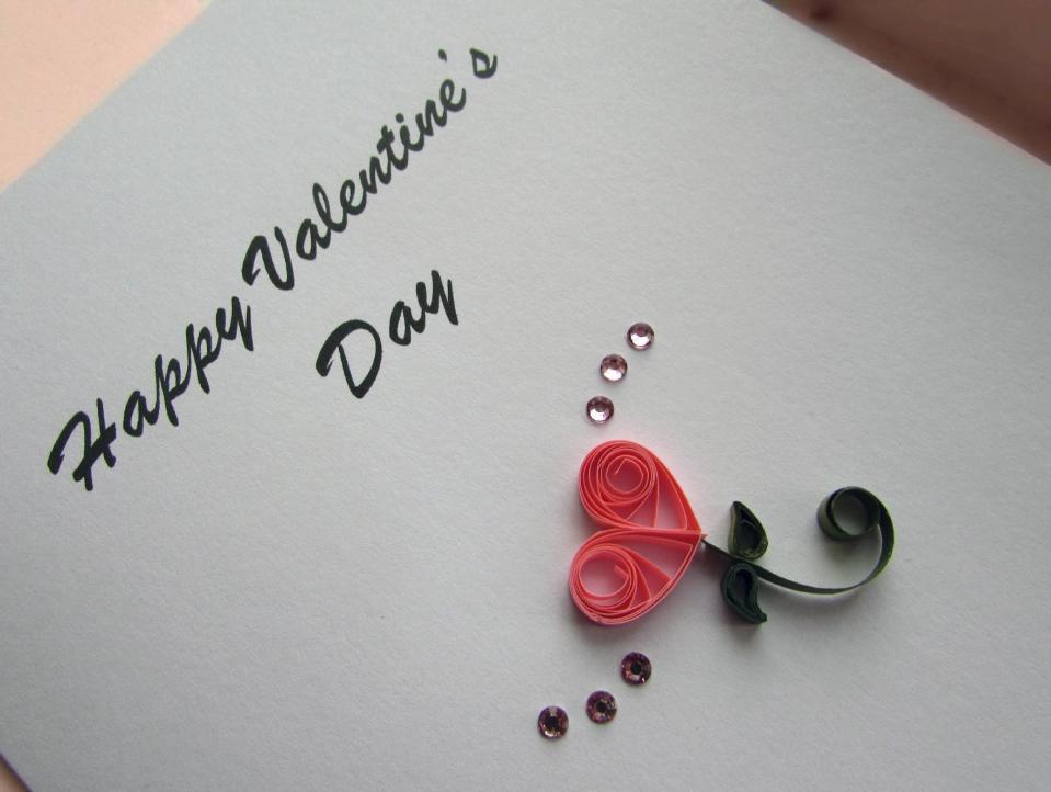 In this image provided by Kari Cronbaugh-Auld of Olathe, Kan., two teardrop coils and two smaller bent teardrop coils combine with an open coil scroll to create a heartfelt message. Quilling, which involves rolling thin strips of paper into various coil shapes and many other techniques, adds extra elegance to a Valentine's Day greeting. (Kari Cronbaugh-Auld/Quillique via AP)