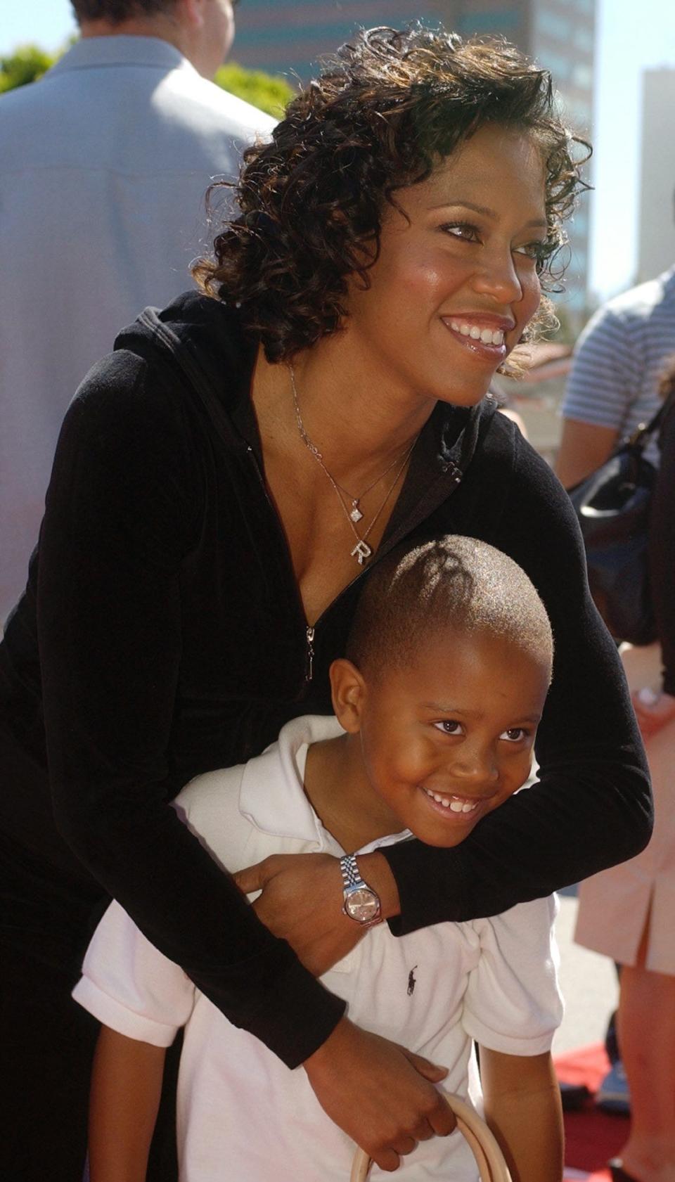 "Daddy Day Care" cast member Regina King arrives with her son, Ian, at the premiere of the film in the Westwood section of Los Angeles, Sunday, May 4, 2003. (AP Photo/Chris Pizzello) ORG XMIT: CACP204