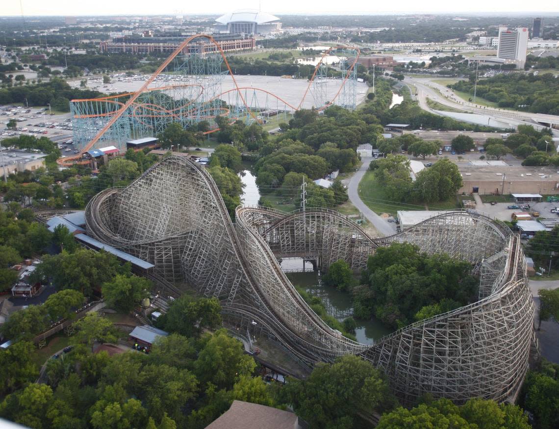 June 6, 2009: Six Flags roller coasters The Titan (foreground) and The Texas Giant (left) are seen in front of the ballpark in Arlington (top left), home of the Texas Rangers baseball team, and the new Dallas Cowboys stadium (top center) on the day of the first event at Cowboys stadium.